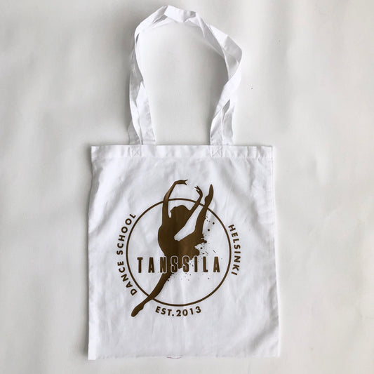 Tanssila, valkoinen kassi kultaisella logolla